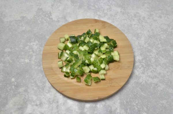 Wash the cucumbers, dry them, and trim the ends. Taste the cucumbers to ensure they are not bitter, as bitter cucumbers can negatively affect the overall flavor of the dish. Cut the cucumbers into small pieces.

