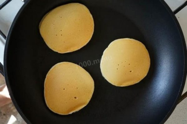 Once they're done, place the pancakes on a plate and top them with your choice of jam, syrup, berries, honey, or anything you prefer.


