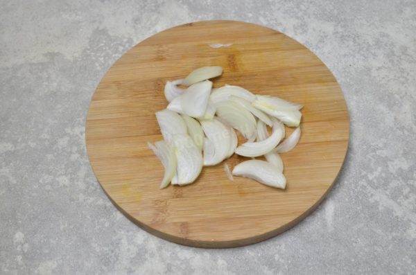 Peel the onion and slice it into thin strips or feathers.

