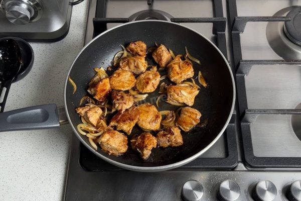 Lower the heat at this point. Continue cooking the meat for the required duration, which depends on the specific cut and size of the pieces. Do not cover the pan with a lid. To check if the meat is ready, you can cut a piece; if the juices inside run clear, it's done. Season the fully cooked meat with salt and mix well.

