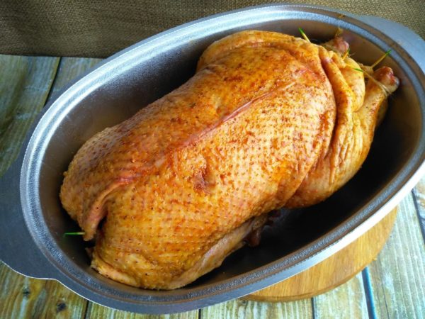 Reapply the marinade to the goose and place it in a roomy roasting pan with its belly facing upward. Roast the goose in the preheated oven for about 40 minutes, or until it achieves a golden brown color. Adjust the exact baking time and temperature according to your oven.

