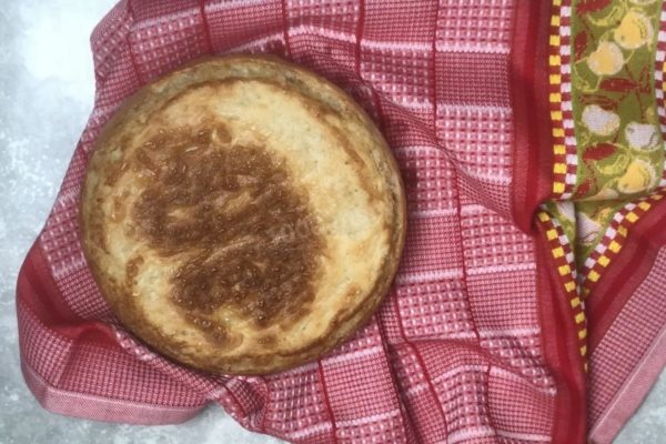 Remove the finished bread from the pan and wrap it in a towel for an hour. After an hour, the bread will cool down and will be ready to eat. Enjoy!