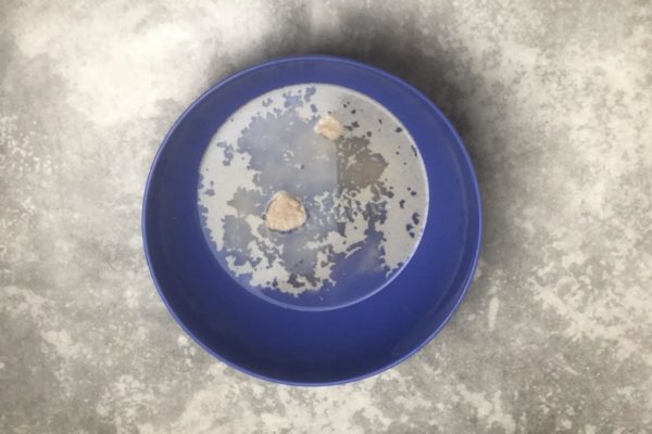 Take a large bowl, as you'll be working with a significant amount of dough. Warm the water to about 38°C (100°F); this should feel pleasantly warm to the touch. It's in this water that the yeast will activate and start working. In colder water, the yeast won't activate, while in hot water, they'll be killed. Add yeast, sugar, and salt to the warm water, and mix them together.

