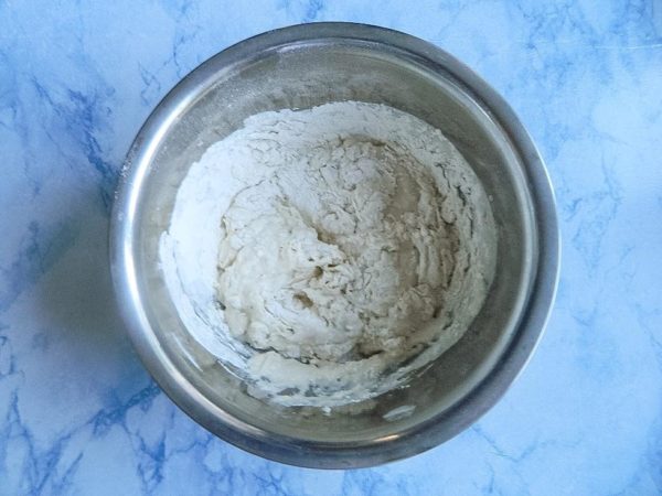 Gradually add vegetable oil and the yeast mixture (dissolved in water) to the well in the flour. Always add the liquid to the dry ingredients, not the other way around, for the best results. Depending on the flour's characteristics, you may need to add flour in small portions to achieve the desired dough consistency. You can find more information about flour and its properties in a separate article linked at the end of the recipe.



