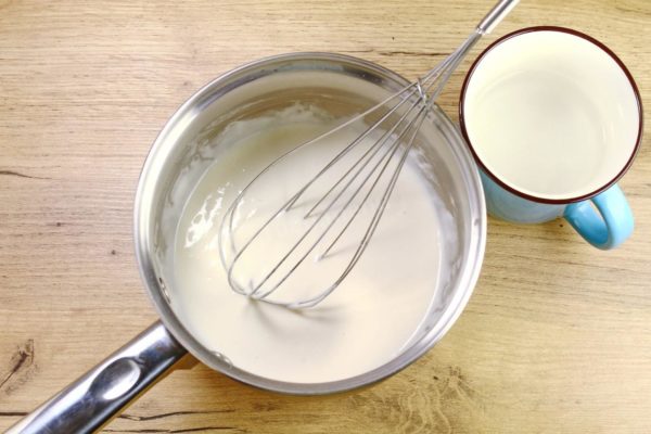 Sift the flour into a saucepan or a small pot (no larger than 2 liters in volume). Sifting the flour helps remove any small debris if present. Add approximately half a cup of water and stir until you have a smooth mixture with no lumps. Using a whisk works best for this.

