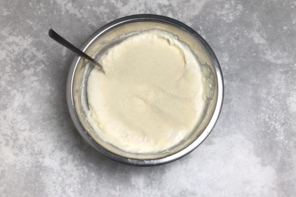 Incorporate semolina, adjusting the quantity based on the initial thickness of the mixture. Use less for thicker mixtures, and more for thinner ones. Keep in mind that semolina will further expand during baking, so don't overdo it.
