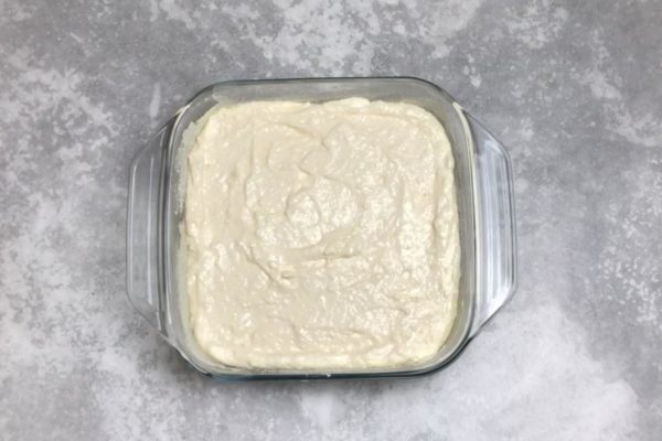 Pour the mixture into the prepared baking dish and smooth the top with a spatula. The size of your dish will affect the height of the casserole.
