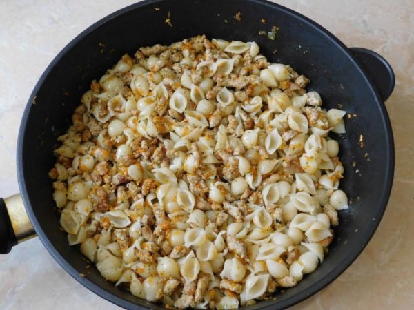 Combine the cooked pasta with the ground meat mixture and serve on plates. Enjoy your meal!
