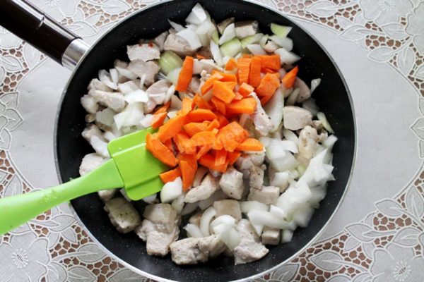 Add the chopped carrots to the pan. Thoroughly mix everything together and simmer until the vegetables are partially cooked.

