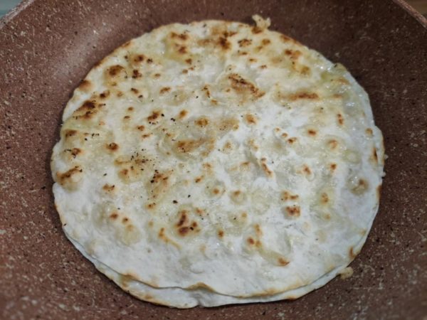 Carefully flip the pita bread so that the "egg" side is down. Be sure to use a good-quality frying pan to prevent the egg from burning.

