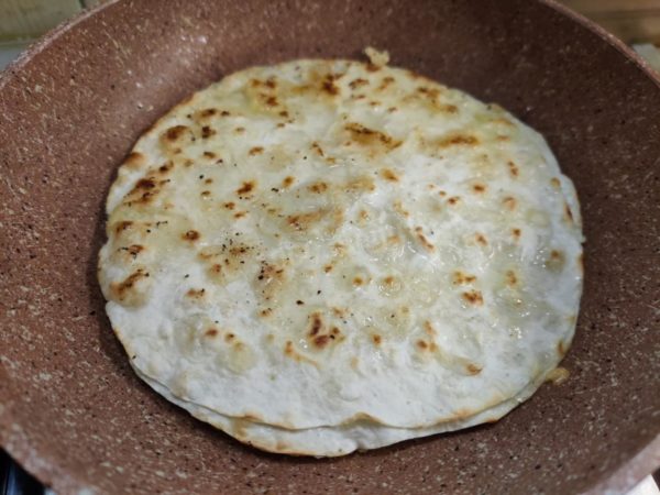 Add another tablespoon of water to the pita bread. Be cautious of the hot steam produced by this step.

