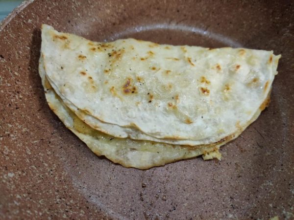 Flip the pita bread again and fold it in half. Your dish is ready! Serve it while it's hot. Enjoy!

