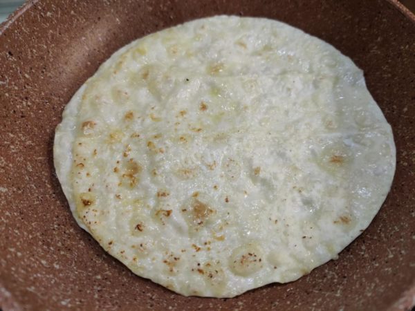 Flip the pita bread to the other side.


