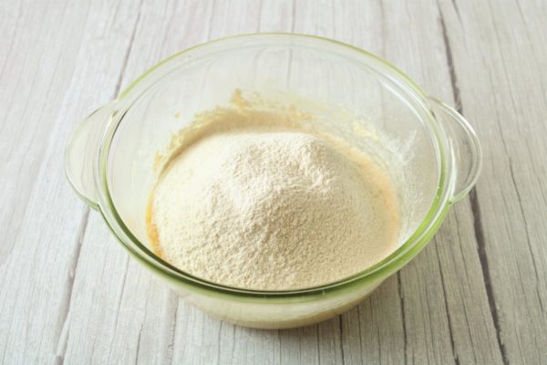 Pre-mix the flour with salt, baking powder, and vanilla extract, then sift it into the dough. Sifting the flour promotes better rising of the cookies during baking. Keep in mind that the amount of flour may vary, so adjust based on the dough's consistency. Learn more about substituting vanilla extract and using baking powder in baking from separate articles provided at the end of the recipe.

