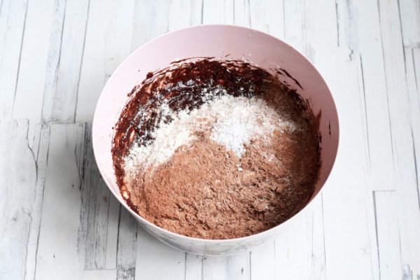 Pour the flour mixture along with salt into the dough. It's recommended to use regular table salt for this recipe, as large or sea salt crystals may not have enough time to dissolve during the short baking time, resulting in a crunchy texture. Salt adds a flavor contrast to the cookies, but you can omit it if you prefer.

