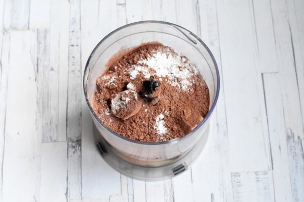 In a blender, combine the banana pieces, eggs, cocoa, and baking powder. Can baking powder be substituted with baking soda? It's not recommended in this recipe since there's no acidic component to activate the soda. Baking powder works perfectly fine here. If desired, you can add a little heat-resistant sweetener, although the natural sweetness from bananas is usually sufficient.

