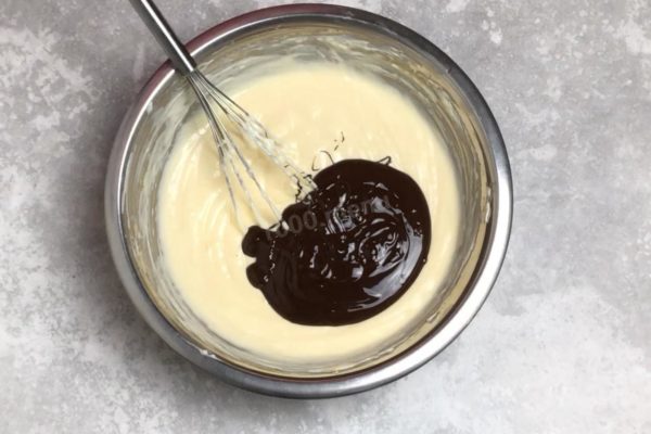 Add the cooled melted chocolate to the mixture and mix well.


