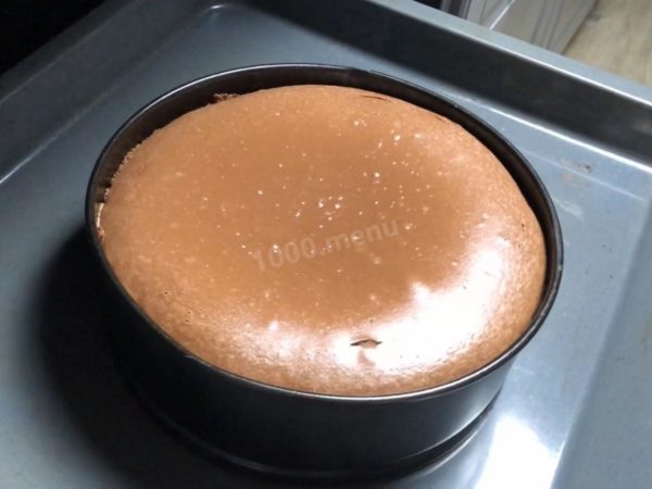 Bake the cheesecake for 1.5-2 hours at 130 degrees Celsius, using both top and bottom heat. Place a container of water on the bottom rack of the oven. After 1.5 hours of baking, monitor the cheesecake's surface. It should not brown excessively; the top should set but remain slightly wobbly. Once this occurs, turn off the heat.

