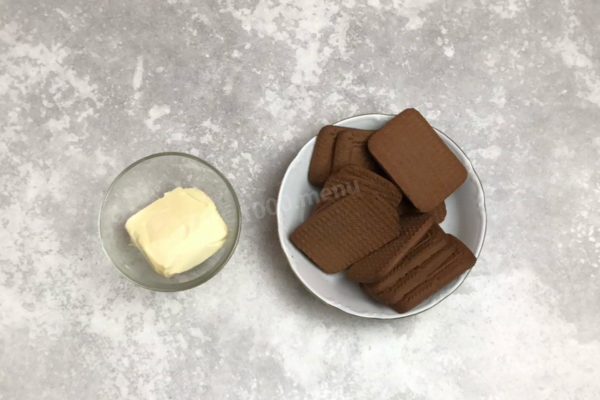 How to make a Chocolate Cheesecake? Let's begin by preparing the cheesecake base. Gather the necessary ingredients. Since this is a chocolate cheesecake, opt for chocolate cookies. If using regular cookies, add cocoa powder to taste along with a spoonful of milk. Ensure the butter is of high quality, meeting GOST standards.

