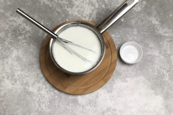 Pour the kefir into a ladle and gently warm it up over low heat while stirring to prevent curdling. Add baking soda to the warm kefir and whisk. The reaction between the warm, sour kefir and baking soda will cause the mixture to bubble and expand, providing fluffiness to the pancakes.

