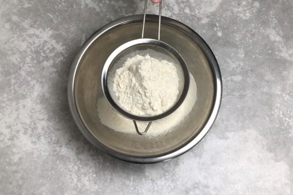 Sift the flour into a large bowl. Sifting adds air to the flour, resulting in lighter pancakes.

