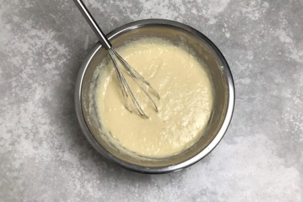 Gradually pour the liquid mixture into the flour while whisking continuously. This prevents lumps from forming. Stir until the flour is evenly incorporated, but don't overmix to keep the batter airy. You may need slightly more or less flour depending on the consistency.


