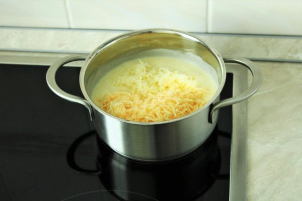 Add the grated cheeses to the sauce, reserving some of the hard cheese for topping the pasta. Omit adding salt to the sauce since cheese contains salt. Adjust seasoning according to taste preference.

