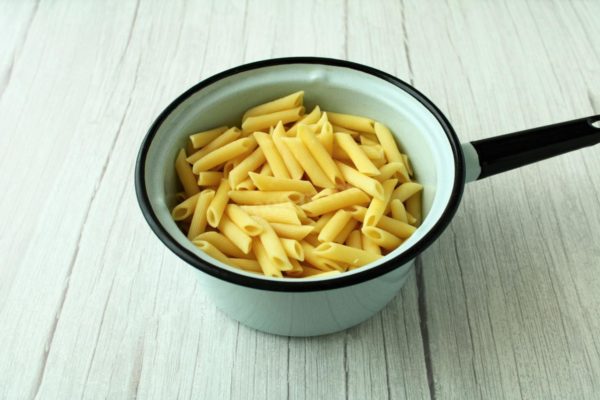 Properly boil the pasta by using a spacious saucepan and adding 1 liter of water per 100 grams of pasta. Season with salt to taste. It's crucial to add the pasta to boiling water to prevent sticking together. Cook over medium heat, stirring occasionally, until al dente (the cooking time is usually indicated on the package). Once cooked, drain the pasta in a colander without rinsing it with water.

