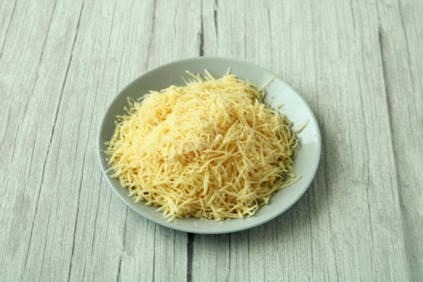 Grate the hard cheese using a medium grater.

