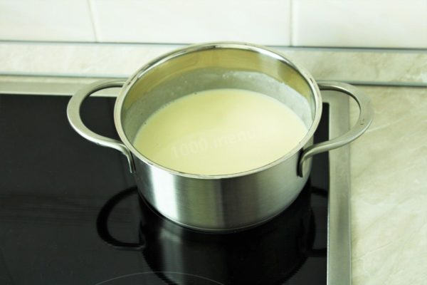 Gradually pour in the milk, stirring vigorously to break up any flour lumps. You can use a whisk for this step. Continue to cook over low heat, stirring frequently, until the sauce comes to a boil and thickens slightly.

