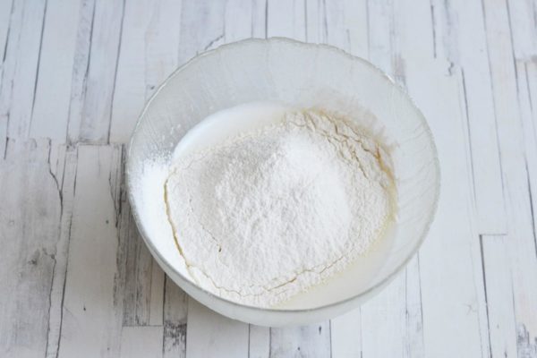 Gradually incorporate the flour mixture into the batter, stirring with a whisk after each addition to break down any lumps. Sifting the flour aids in aerating it, resulting in a lighter and airier batter.

