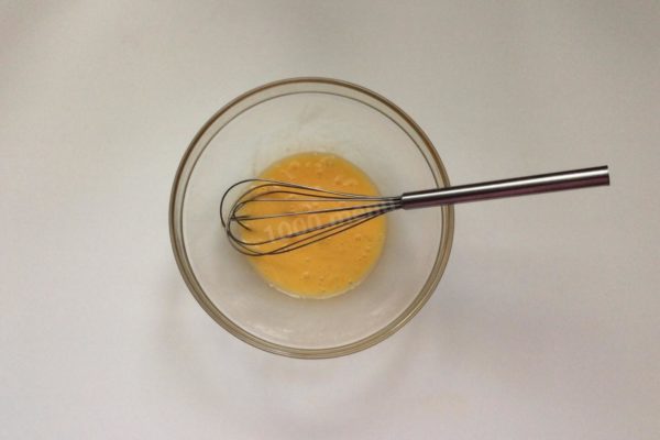 Crack the egg into a mixing bowl and whisk thoroughly. Prior to using the egg, rinse it under cold water with baking soda to eliminate any potential harmful bacteria on the shell.


