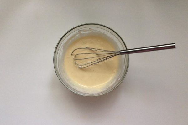 Sift the flour using a sieve or a flour sifter; this step ensures that the pancakes made with water are light and airy. Combine the sifted flour, sugar, salt, and baking powder in a bowl, and whisk until you achieve a smooth batter consistency resembling thick sour cream. Adjust the amount of flour as needed.

