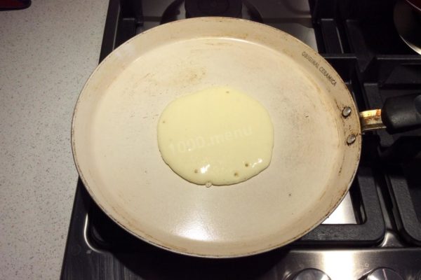 Heat a skillet over medium heat. There's no need to grease the skillet since the added vegetable oil in the batter prevents sticking. Pour about two tablespoons of batter into the skillet and gently spread it out to form a round shape.

