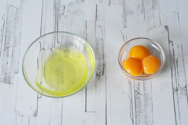 Carefully separate the egg yolks from the whites, ensuring no yolk contaminates the whites to guarantee a perfect rise to foam.


