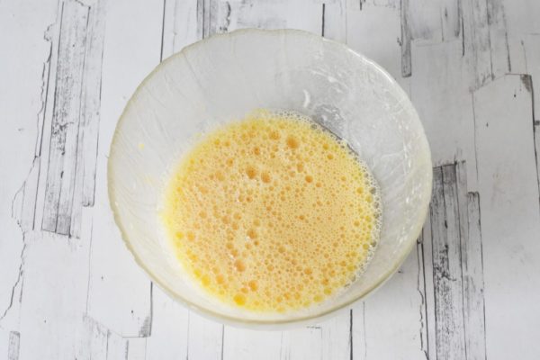 In another bowl, whisk together the egg yolks, room temperature milk, and vegetable oil until the mixture is smooth.


